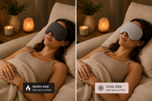 Elevated Rituals reversible sleep mask shown in a relaxing bedroom setting, featuring a dark grey warm side and light grey cooling side for comfortable sleep and relaxation.